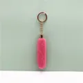 Detail showing soft pink plush fur texture on long gold metal keychain - Rose Red