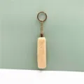 Detail of cute apricot plush tassel keychain with gold-tone ring for bags or car keys - Beige