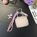 Detailed view of the cute pink plush bag charm with balloon dog and braided strap - Pink