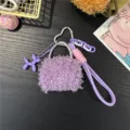 Detailed view of the purple plush mini bag charm with a cute balloon dog pendant - Purple