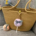 Detailed view of a cute purple pom-pom lollipop keychain with a lace bow on a bag. - 1 Piece / Taro Purple