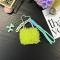 Close-up of a neon green fuzzy bag keychain with a cute balloon dog charm ornament. - Green