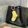 Cute yellow plush sock-shaped bag charm featuring a pink silicone twist knot strap detail - Single OPP Bag Packaging / Goose Yellow
