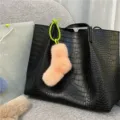 Cute peach plush sock-shaped bag charm with green strap on a black crocodile tote - Single OPP Bag Packaging / Pink