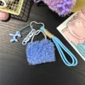 Close-up detail of blue fluffy handbag charm featuring a heart buckle and blue balloon dog - Sky Blue