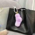 Close-up detail of a soft purple plush keychain with white beaded loop on a black bag - Single OPP Bag Packaging / Purple