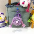 Quirky purple monster plush keychain with colorful braids and star clip for bag decoration - 1 Piece / Purple