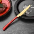 Premium red and gold stainless steel steak knife featuring a sharp serrated blade for dining - Dinner Knife / Red