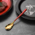 Elegant gold stainless steel spoon with red handle for luxury dining flatware set - Tea Spoon / Red