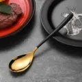 Elegant stainless steel gold and black dessert spoon with a modern matte finish handle - Dinner Spoon / Black