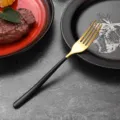 Elegant gold stainless steel dinner fork with a minimalist black handle finish - Dinner Fork / Black