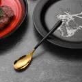 Elegant stainless steel spoon with moon gold head and black handle for modern dining. - Tea Spoon / Black
