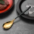 Modern stainless steel spoon featuring a gold mirror finish and matte black handle - Dinner Spoon / Dark Green