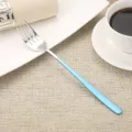 Modern stainless steel fork with a light blue painted handle for dining - Fork / Blue