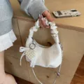 Modern white pleated handbag featuring a delicate lace bow and pearl heart charm accessory - Beige with Pendant