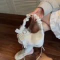 Elegant white ruched handbag featuring pearl bow charms and stylish number print design - Silver With Pendant