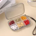 Portable 6-compartment pill box, gray travel mini medicine organizer with lanyard for daily use. - Gray