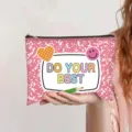 Detail of pink canvas pouch with 'DO YOUR BEST' print and cartoon stickers held in hand. - Pink (Do your best)