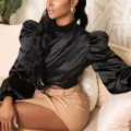 Elegant black satin puff sleeve mock neck crop top paired with a chic tan leather mini skirt. - Tops / Black / S
