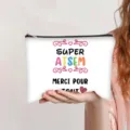 Detail view of a white canvas makeup bag featuring colorful 'SUPER ATSEM' print - French Style (Merci Pour Tout)
