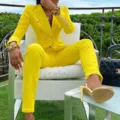 Detailed view of the elegant yellow double-breasted blazer and straight pants suit set. - S / Top And Bottom / Yellow