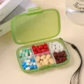 Portable 6-grid pill box travel medicine storage container with secure latch and strap. - Green