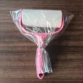 Pink lint roller with tearable sticky paper for efficient clothes and dust removal. - 55-Sheet OPP Bagged Lint Roller (No Colored Paper)