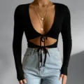 Black long sleeve crop top, deep v-neck, front cutout with drawstring tie, ribbed knit. - S / Tops / Black