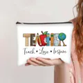 Detail view of a white canvas makeup bag featuring Teacher Teach Love Inspire print - Education Elements Spelling Print (jiayingpbb0663)