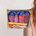 Close-up of watercolor sardine can fish print canvas makeup pouch held by model. - Watercolor Sardine Can Print (jiayingpbb0669)