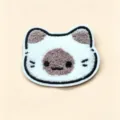 Close-up of cute plush cat head hair pad patch accessory - Siamese Cat Fringe Pad