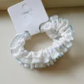 Detail view of small cotton polka dot hair scrunchie with light blue ruffled edge design. - 2 Pieces/Pack / Blue Series