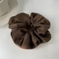 Detailed view of the soft satin texture and folds of a dark brown scrunchie - L / Dark Coffee