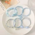 Set of five light blue aesthetic hair ties and scrunchies displayed on a white plate. - 5# Blue Hair Tie 6-Piece Set