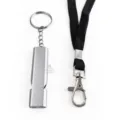 Detail shot of metal survival whistle with black lanyard and keyring, durable outdoor gear. - Silver