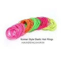 Detailed macro view of colorful seamless thin hair elastics in fluorescent shades. - 100 Pieces/Pack (OPP Bag) / Fluorescent Colors