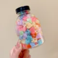 Close-up of colorful mini heart-shaped hair claw clips stored in a clear plastic jar - 5# Jelly Heart Style
