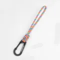 Handmade paracord keychain lanyard detail, colorful braided rope with black metal carabiner hook. - Streamer Ribbon