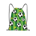 Close-up view of a green striped drawstring bag with soccer ball and golden crown pattern - Crown Soccer Green Stripe Style (jiayingskd118) / 34x41cm