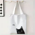 Primer plano de un bolso de lona blanca con un lindo gato negro y el estampado 'Hi' - Hi Gato (jiayingstd256) / 34x39cm