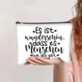 White canvas cosmetic bag featuring German quote and black zipper for versatile storage - German Inspirational Text Print (jiayingpbb0681)