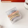 Assorted pastel braided elastic hair ties inside a clear acrylic square storage box - 50 Pcs Bag / Macaron Color
