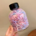 High elasticity colorful rainbow kids hair bands stored in a clear jar with a black lid - 1283B Jelly Color / Approx. 1000 Pieces