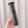 Set of black seamless high-elasticity hair ties in a clear cylindrical storage tube - 20 Pieces / Black Series
