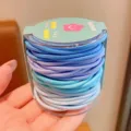 Detailed view of assorted blue and purple elastic hair ties in round packaging - 48 Pieces per Set / Blue Series