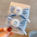 Close-up detail of blue tweed bow hair clips with white mink fur and heart gemstone. - Bowknot Hair Clip Pair / Blue