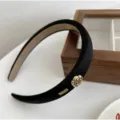Elegant black velvet wide headband decorated with gold camellia and metal tag detail - Camellia Decoration Style / Black