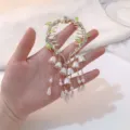 Elegant Lily of the Valley hair claw clip with delicate white flower and pearl tassels. - Vine Lily of the Valley