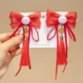 Close-up of red Chinese New Year hair clips with bows, tassels, and cute rabbits. - Chinese Knot Rabbit Style (D169---6)