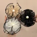 Detailed view of three elegant 8cm mesh flower hair claw clips with pearls - Black, Cream White and Champagne